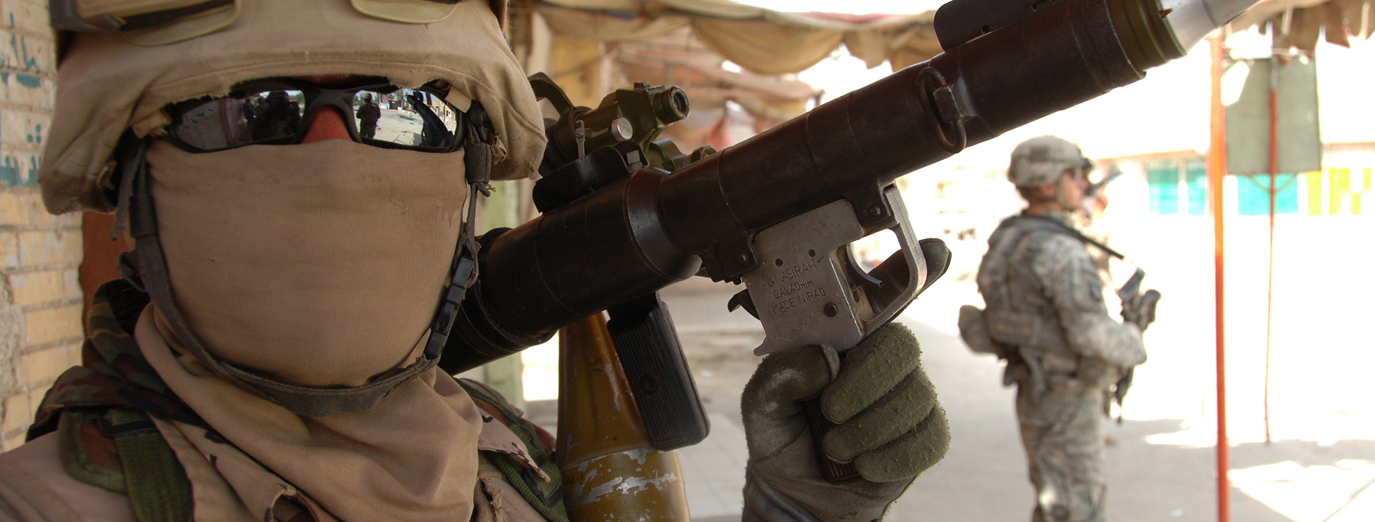 An Iraqi army soldier poses for a picture with his weapon during a mission in Mahmudiyah, Iraq, March 30, 2008. US Army photo by Spc. Richard Del Vecchio